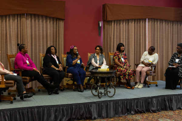 Image of six people on a stage speaking at the 2019 WI Cancer survivor ship summit