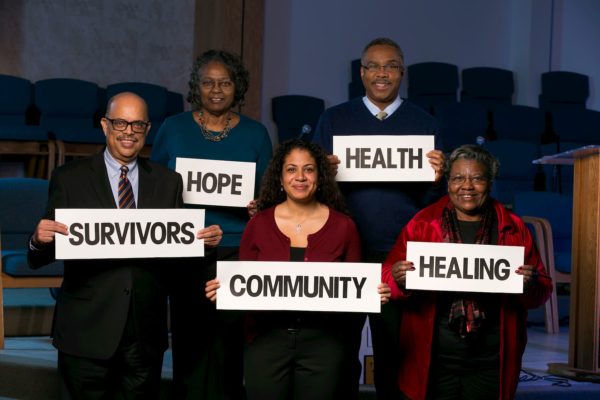 Image of people holding inspirational signs