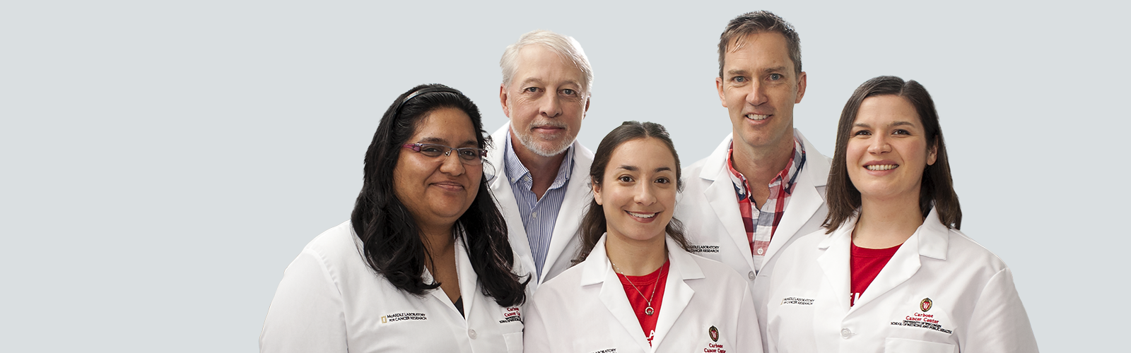 Five UW Health physicians in their lab coats posing for the camera.