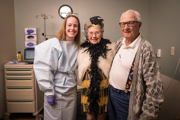 Three people dressed up on a patient's final day of treatment.